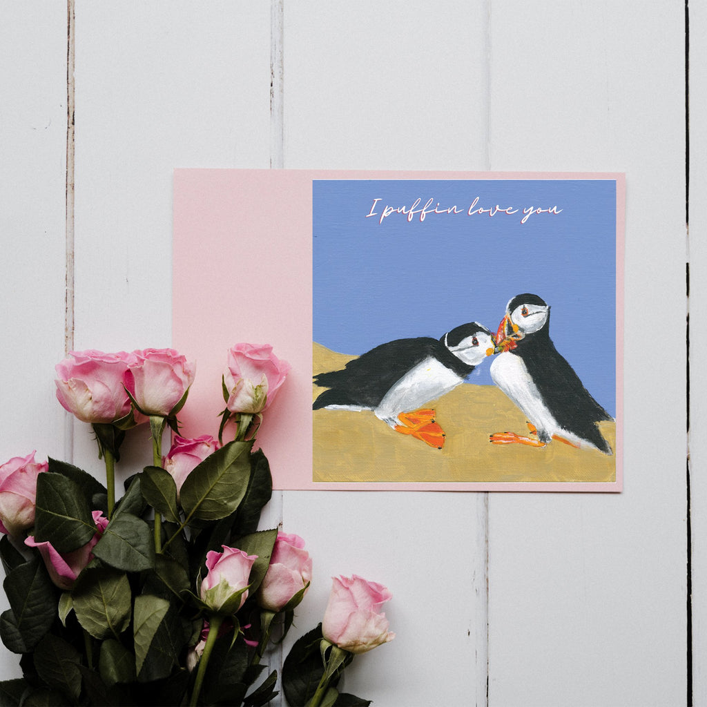 I Puffin Love You Greetings Card with two puffins kissing on a blue background