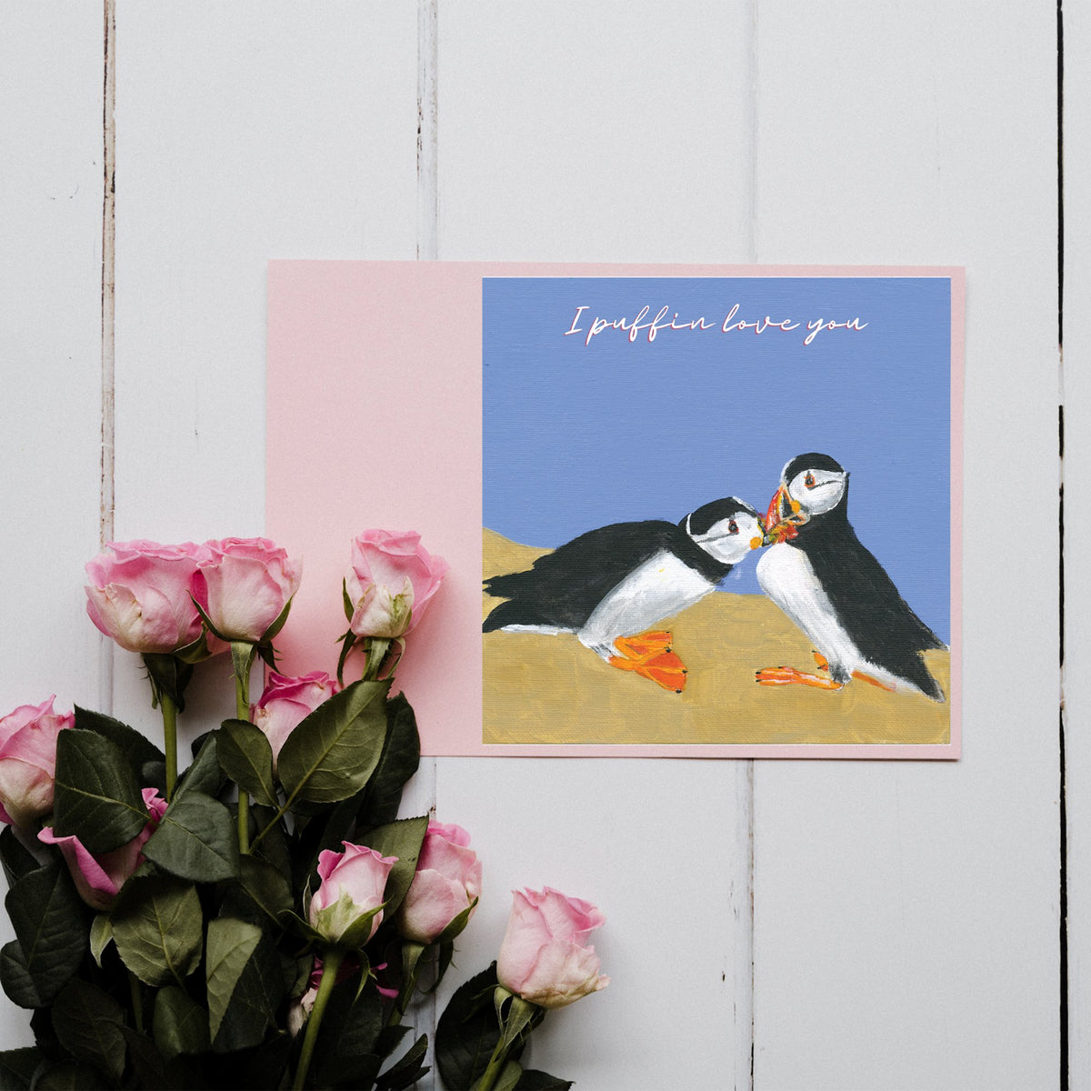 I Puffin Love You Greetings Card with two puffins kissing on a blue background